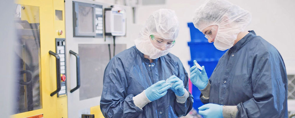 Clean room employees inspecting components